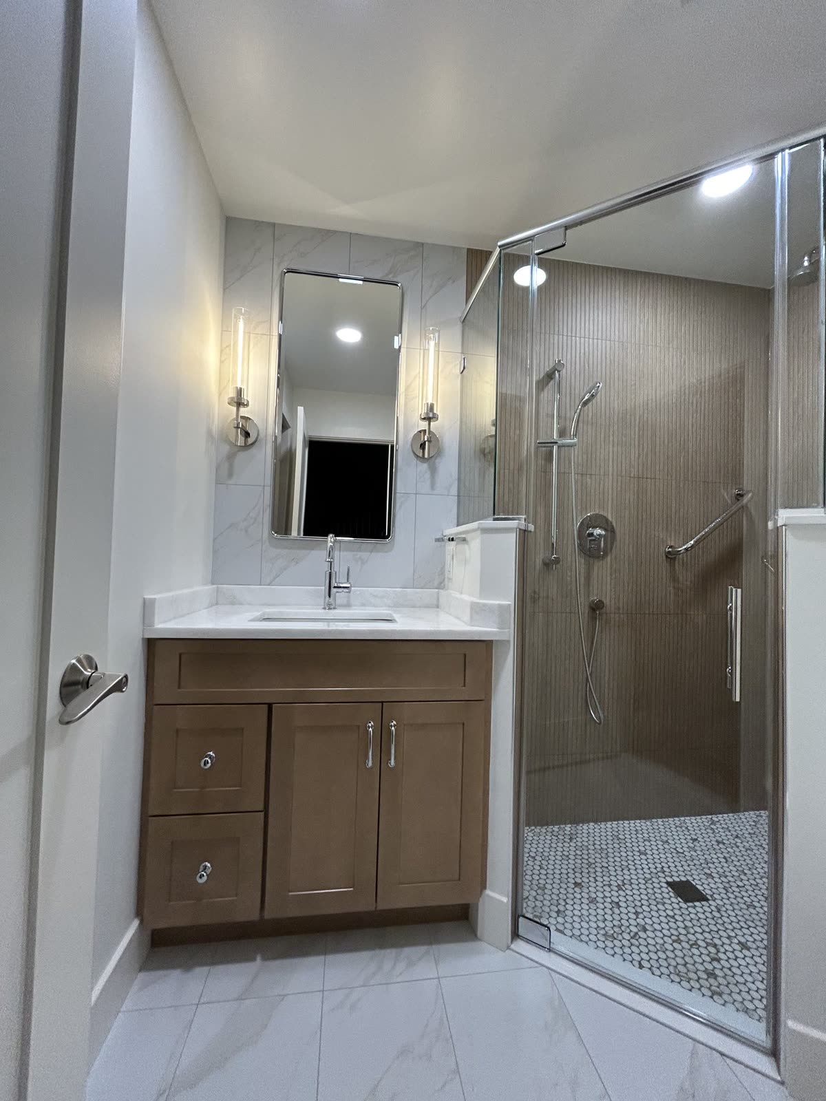 Bathroom with wood vanity and glass walk-in shower