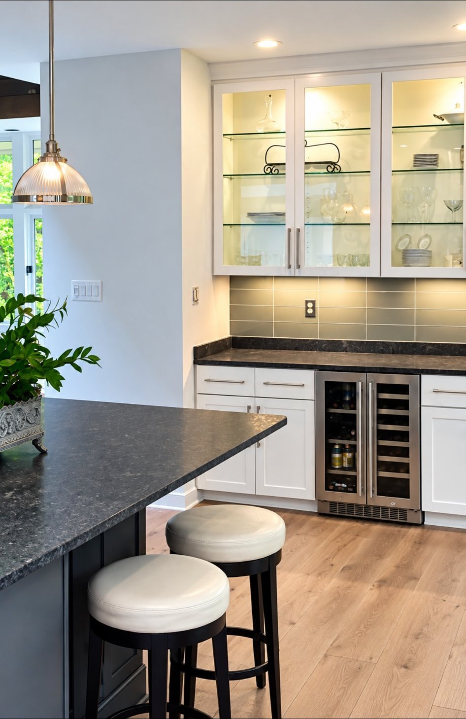 Kitchen with glass-front display cabinets and built-in wine fridge