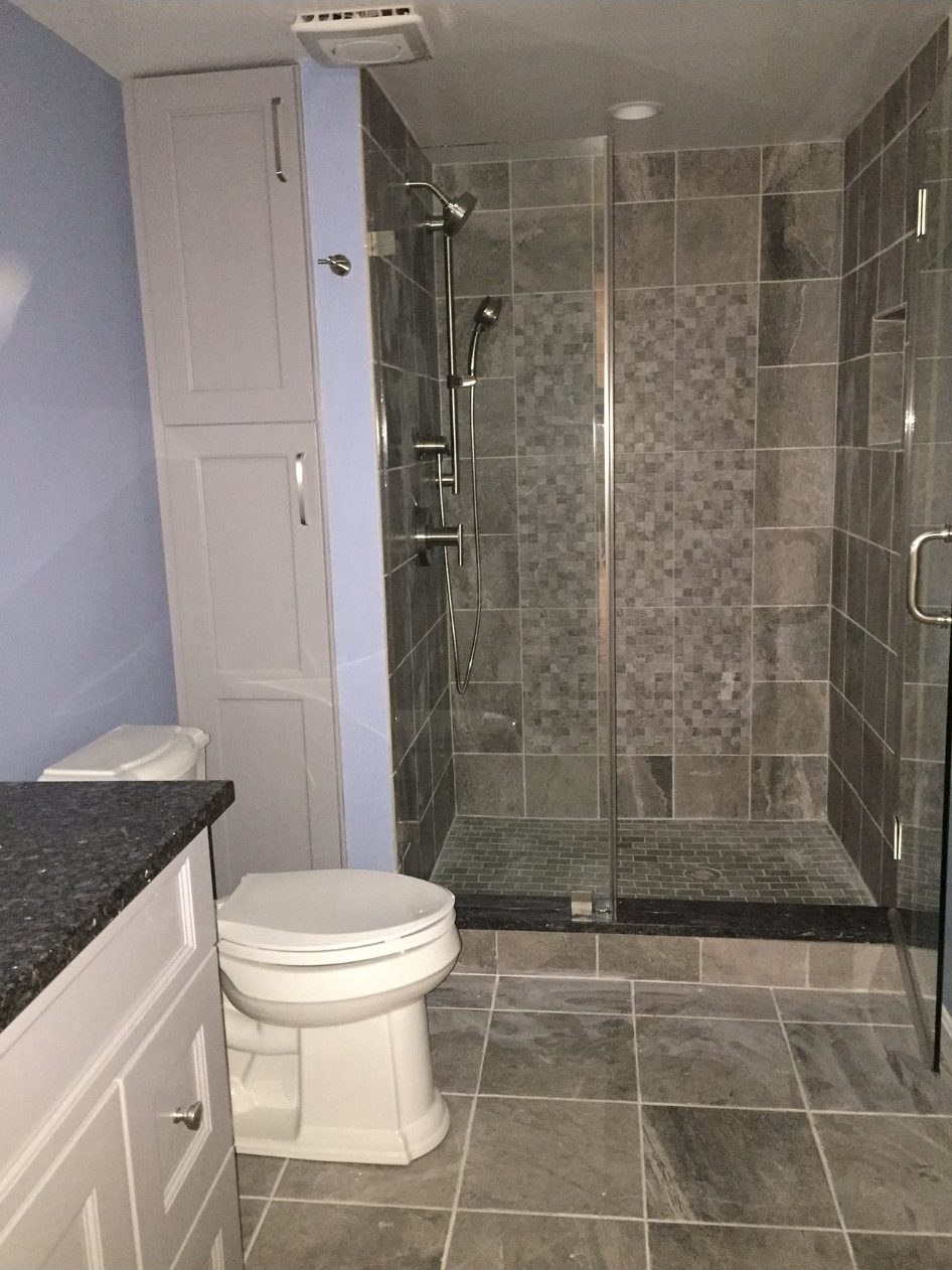 Remodeled bathroom with walk-in shower, toilet and vanity