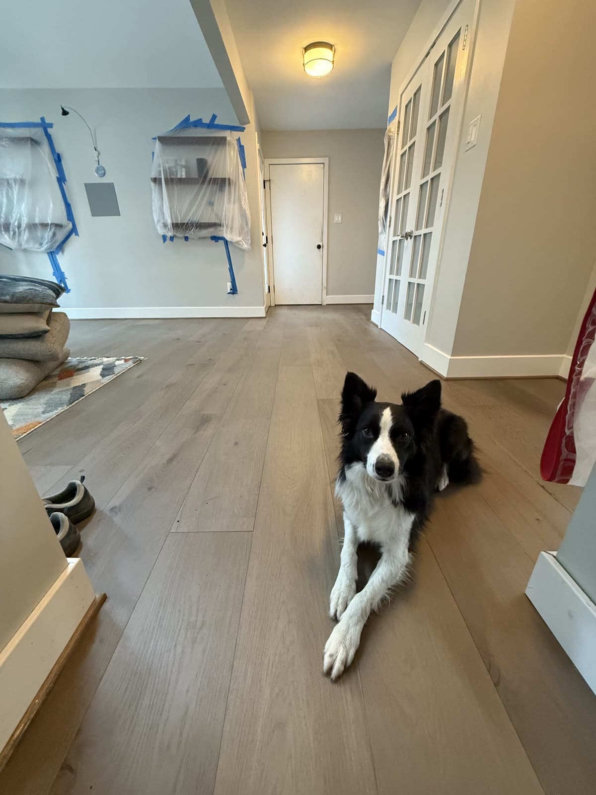 New hardwood flooring being installed in a hallway