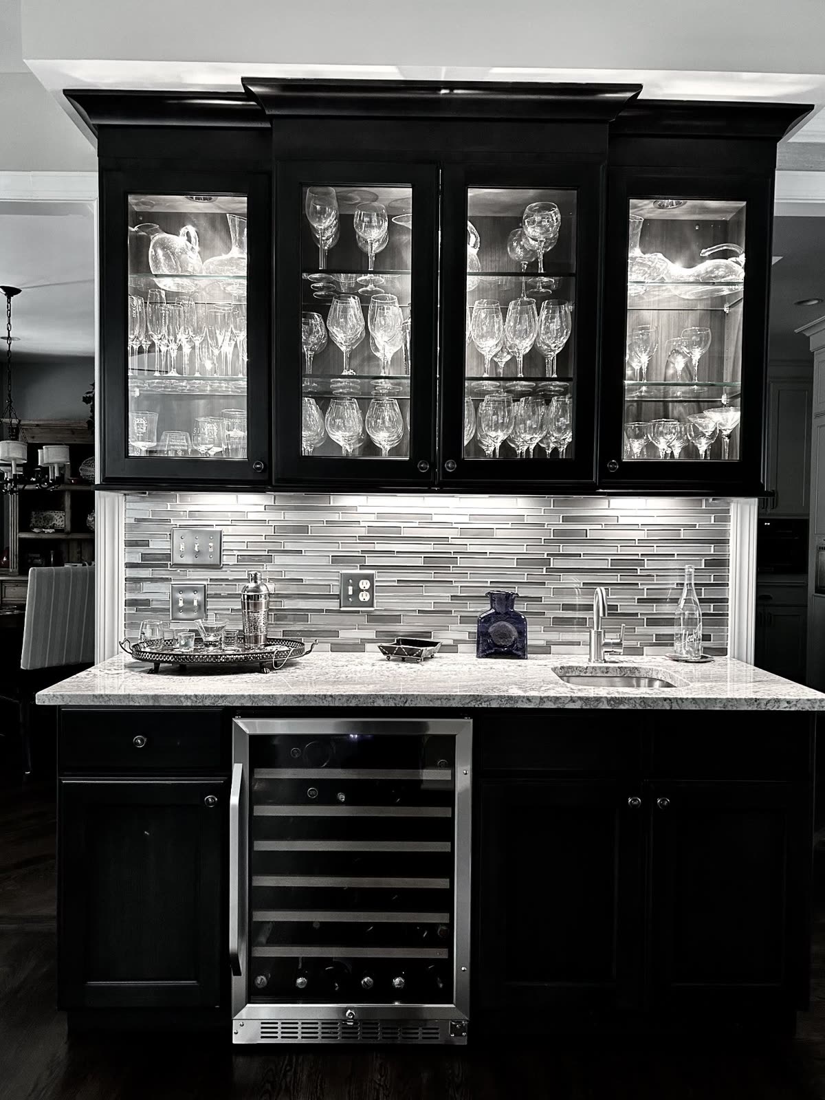 Dark wet bar with glass cabinets